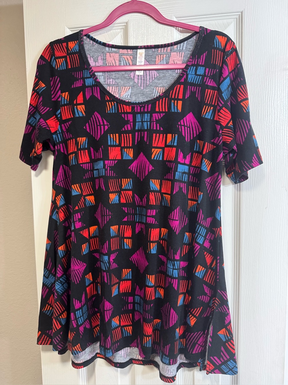 LuLaRoe Perfect Tee. Black w/ purple & pink pattern. High low hem. Side slits.